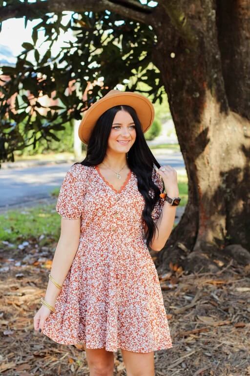 modeling posing while wearing a floral dress