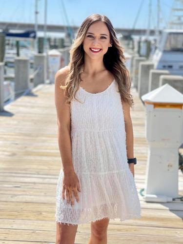 woman wearing a white dress at a marina