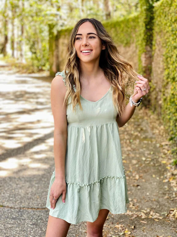 model wearing a green tiered dress