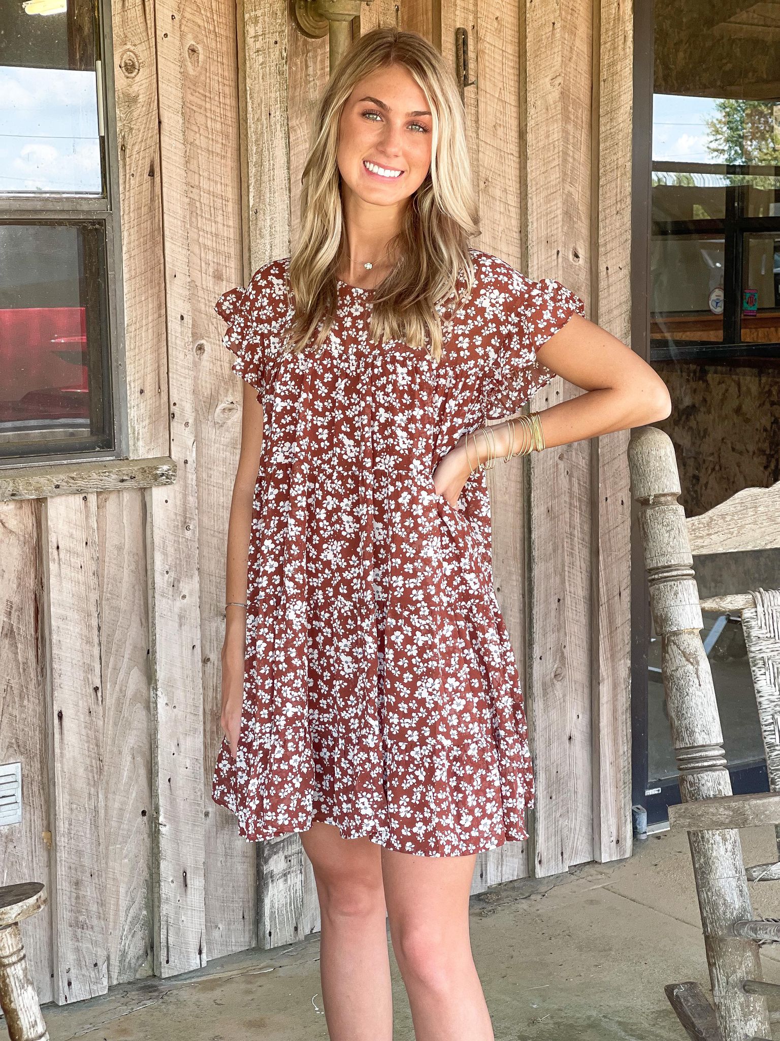 model posing in a maroon floral dress