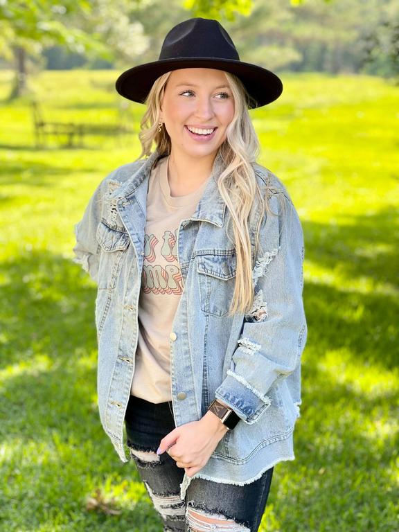 Woman wearing black hat and denim jacket