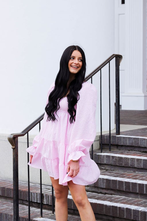 model wearing a pink gingham dress